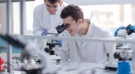 Group of young medical students doing research together in chemistry laboratory,teamwork by college student indoors